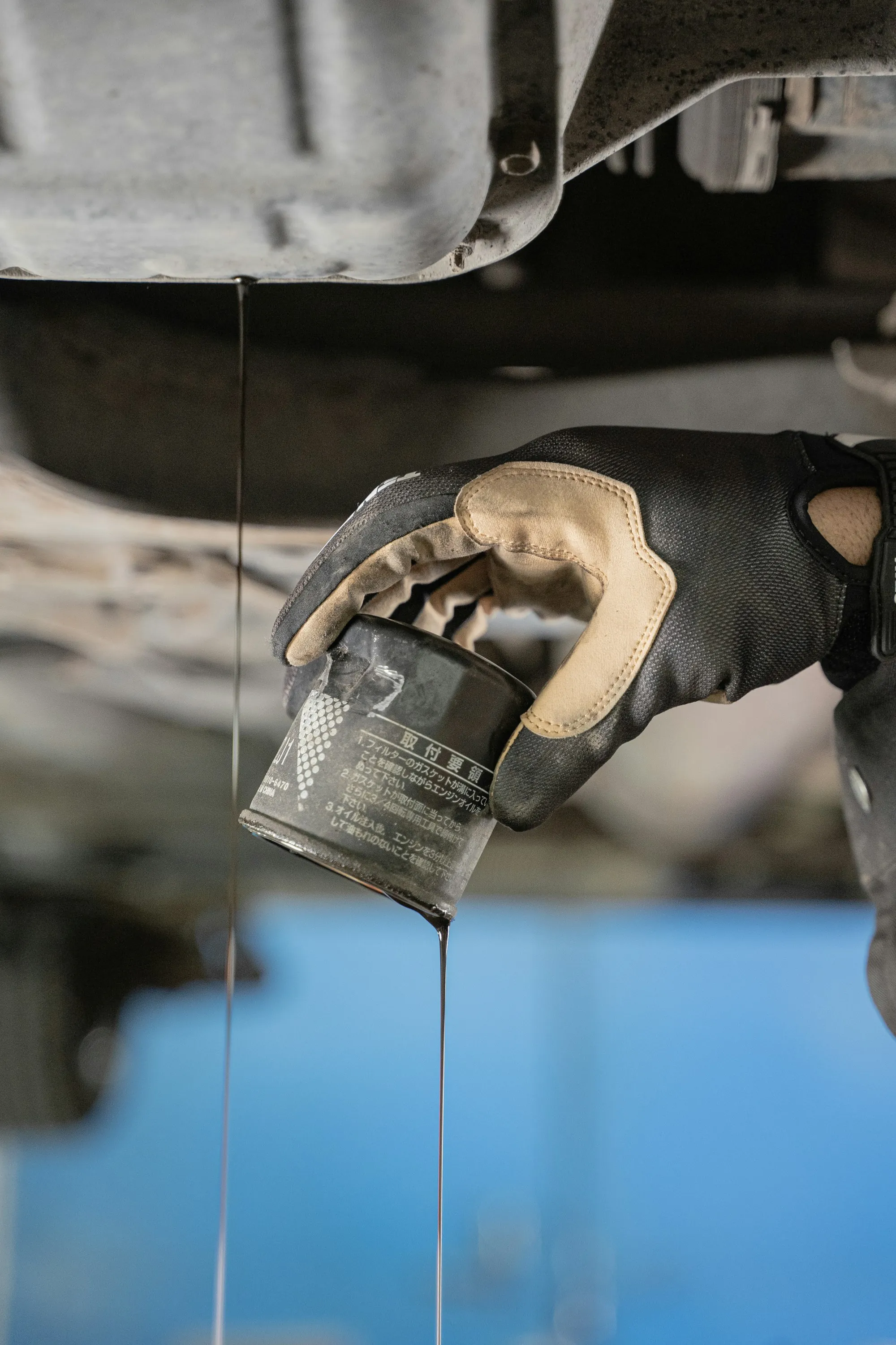 Oil filter being removed under a car